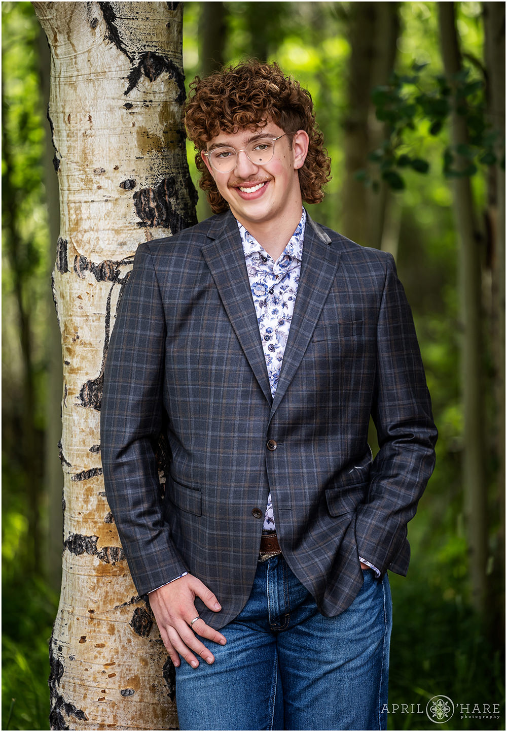 High School boy poses for his yearbook portraits in a grove of aspens in Frisco Colorado