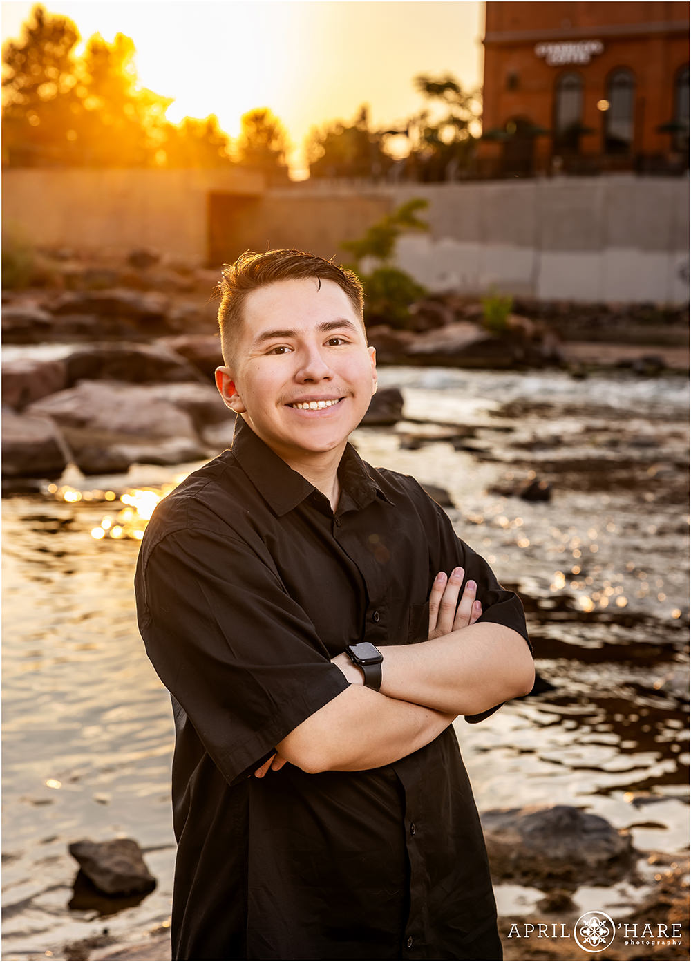 Warm sunset light on the South Platte River for a senior photo at Confluence Park in Denver