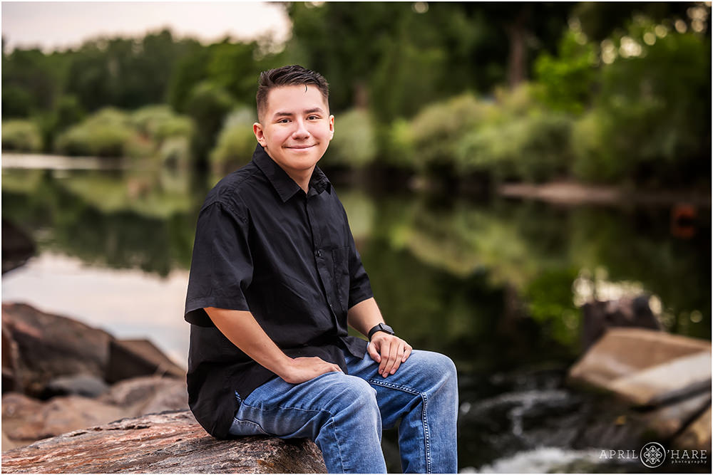 Classic Senior Photo of a young man with the peaceful South Platte River in the background in Denver Colorado
