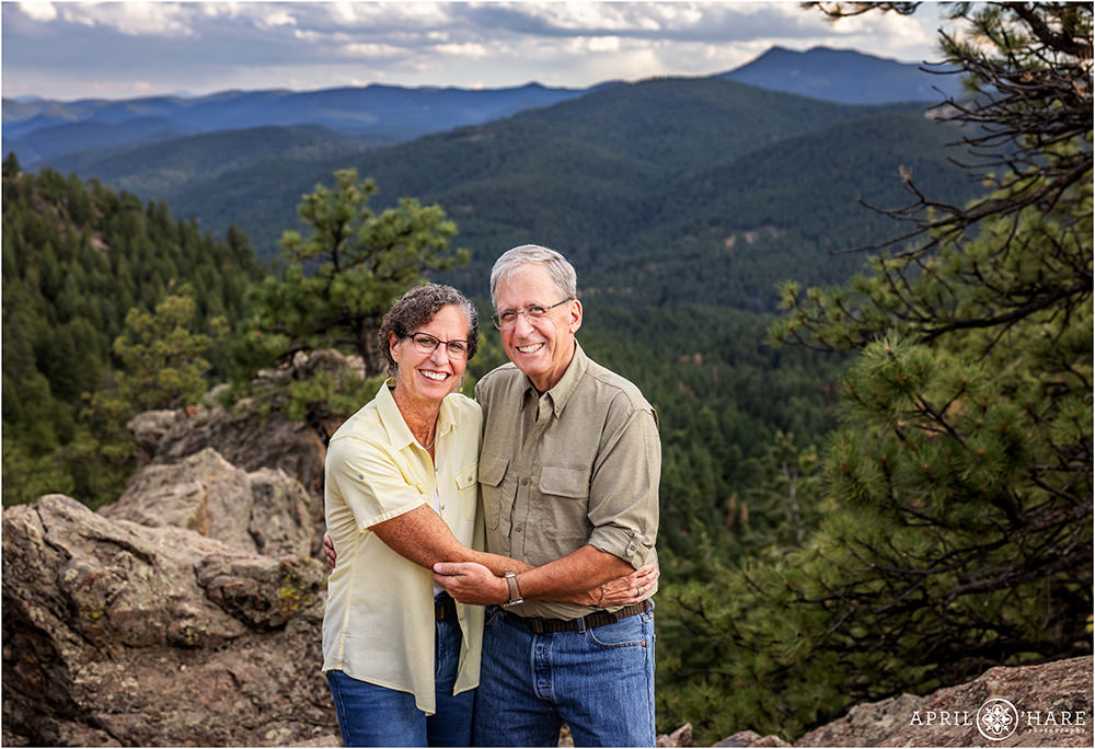 Couple laugh together as a pose for a photo at West Mount Falcon
