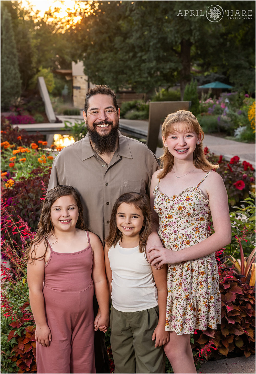 A dad with his three daughters at Denver Botanic Gardens at Sunset in Colorado