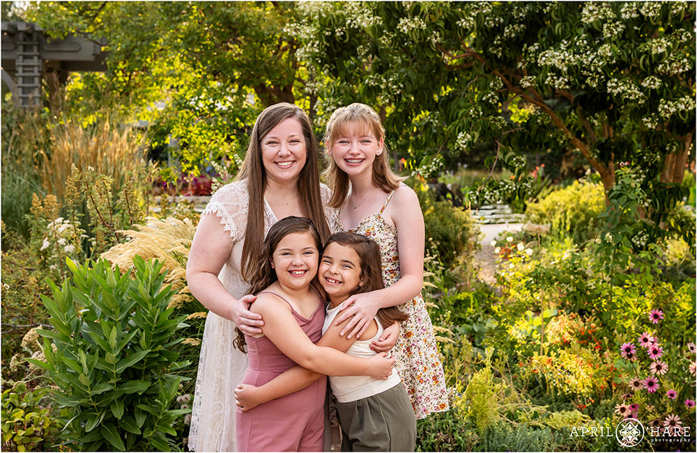 A mom with her three daughters in a pretty garden setting at Denver Botanic Gardens in CO