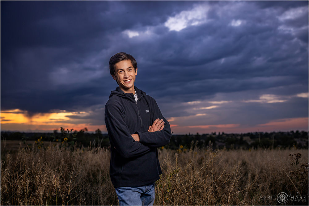 Senior photo with pretty colorful sunset sky at Castlewood Canyon State Park