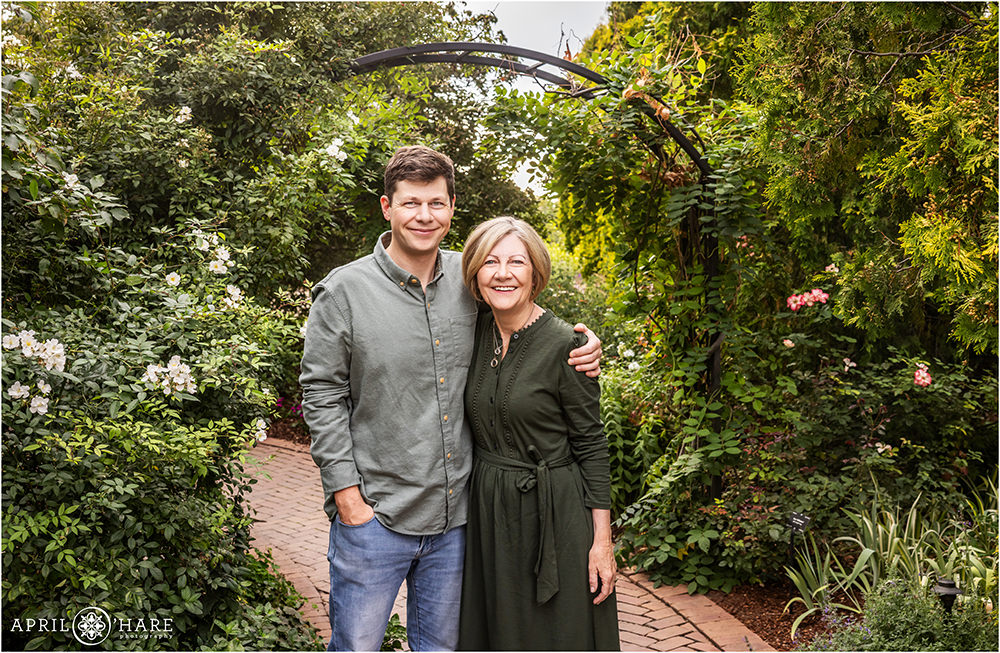 An adult son poses for a photo with his mom at his family photoshoot at Denver Botanic Gardens