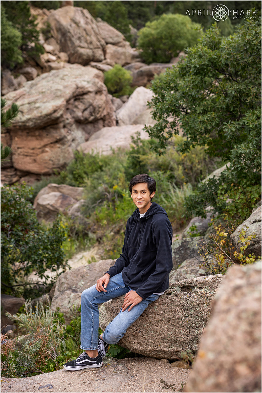 Senior photo with rocky backdrop at Castlewood Canyon State Park
