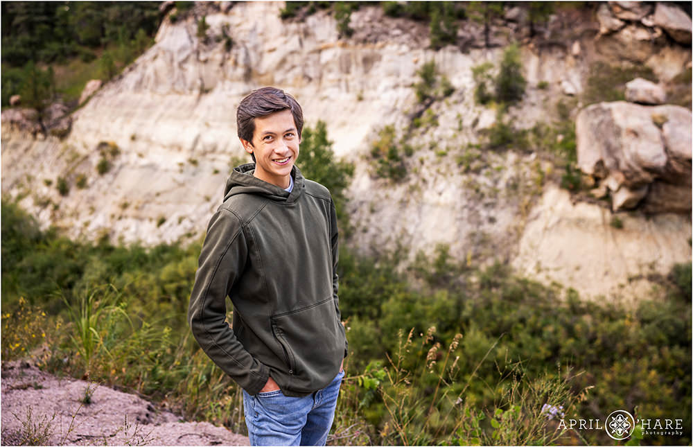 Senior Photo with white cliff backdrop at Castlewood Canyon State Park