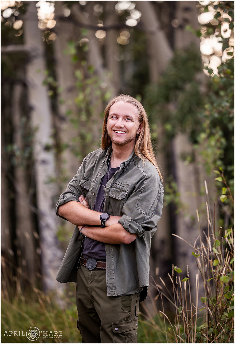 High school senior portrait with aspen tree backdrop in Evergreen Colorado