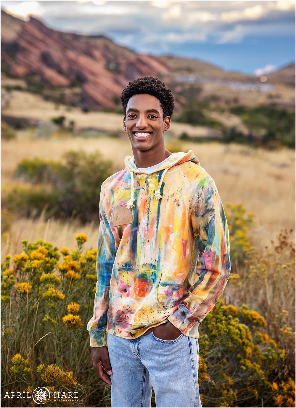 Colorful high school senior photo at sunset at the Morrison Trailhead with Red Rocks in the backdrop