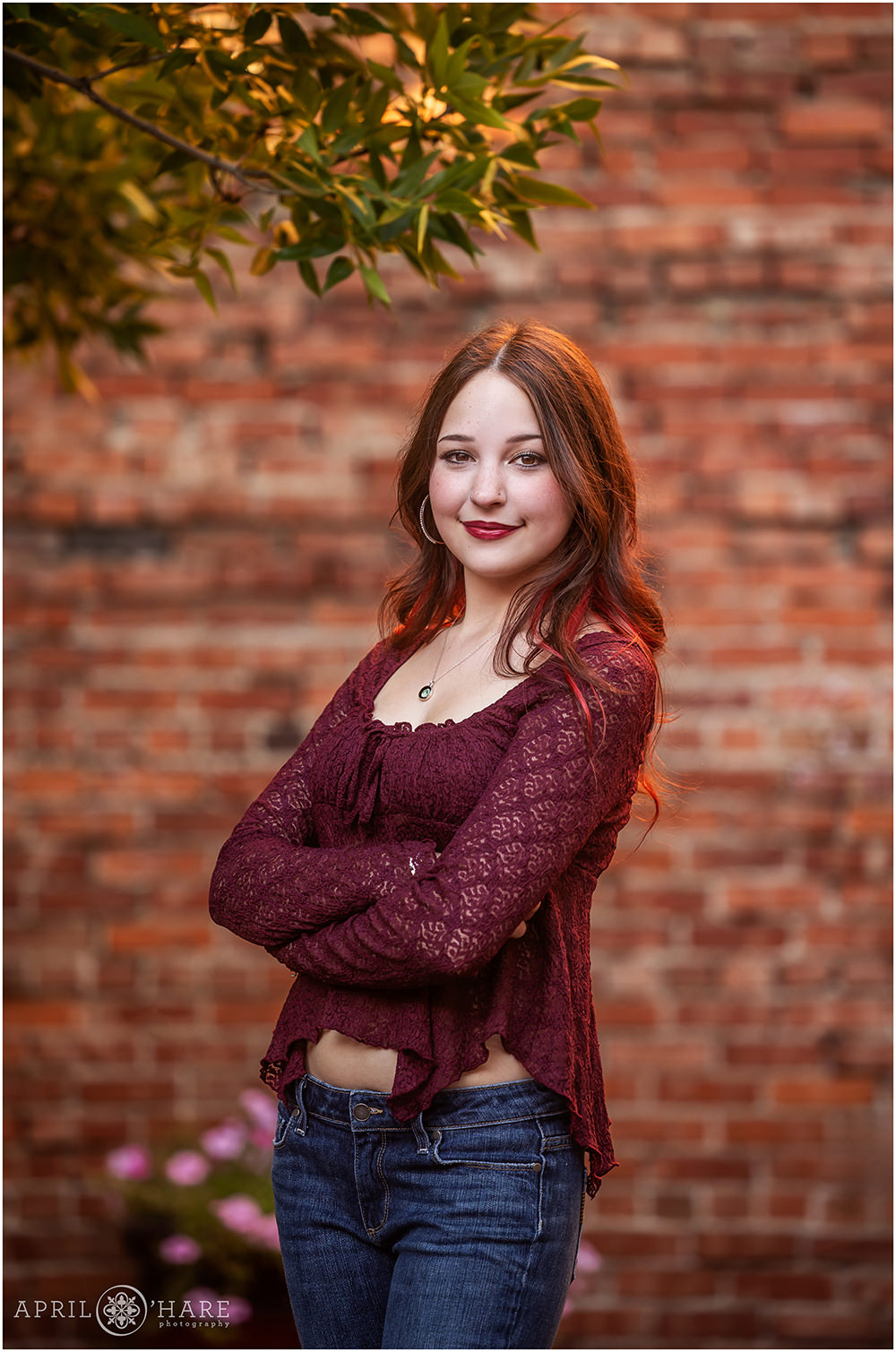 Textured red brick wall backdrop for a downtown Denver senior portrait in Colorado