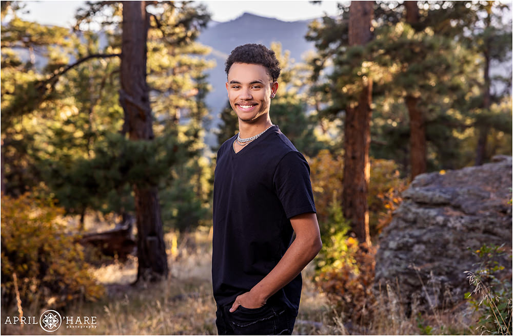 Pretty forest backdrop with mountain scenery at West Mount Falcon Senior Photoshoot in Colorado