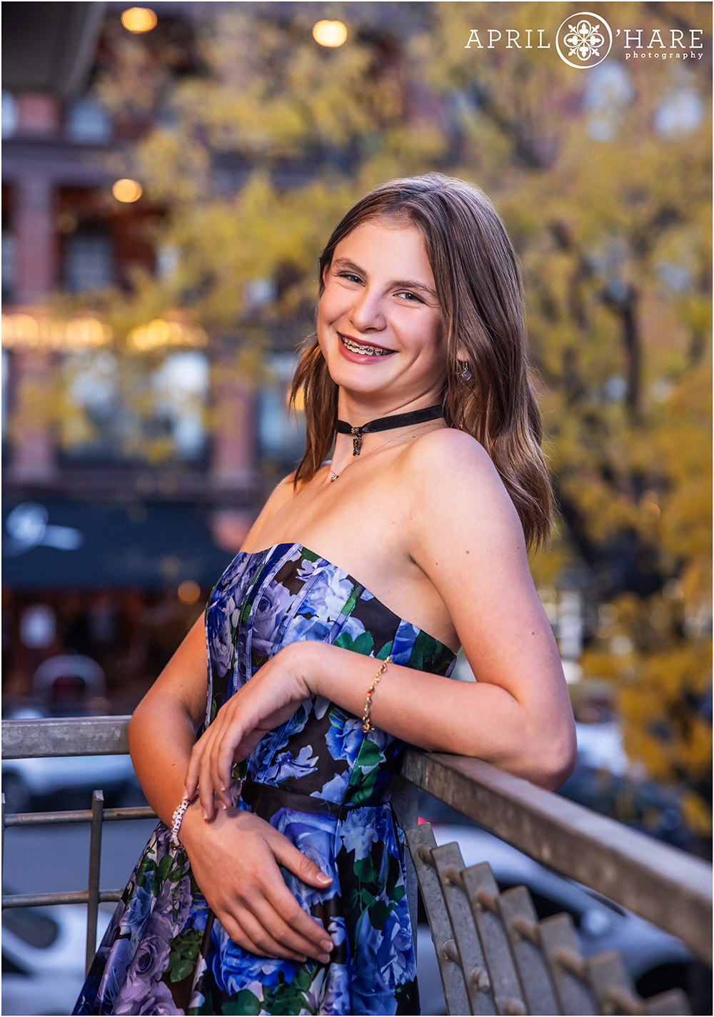 Pretty portrait of a bat mitzvah girl with fall color tree backdrop at Rembrandt Yard in Boulder Colorado