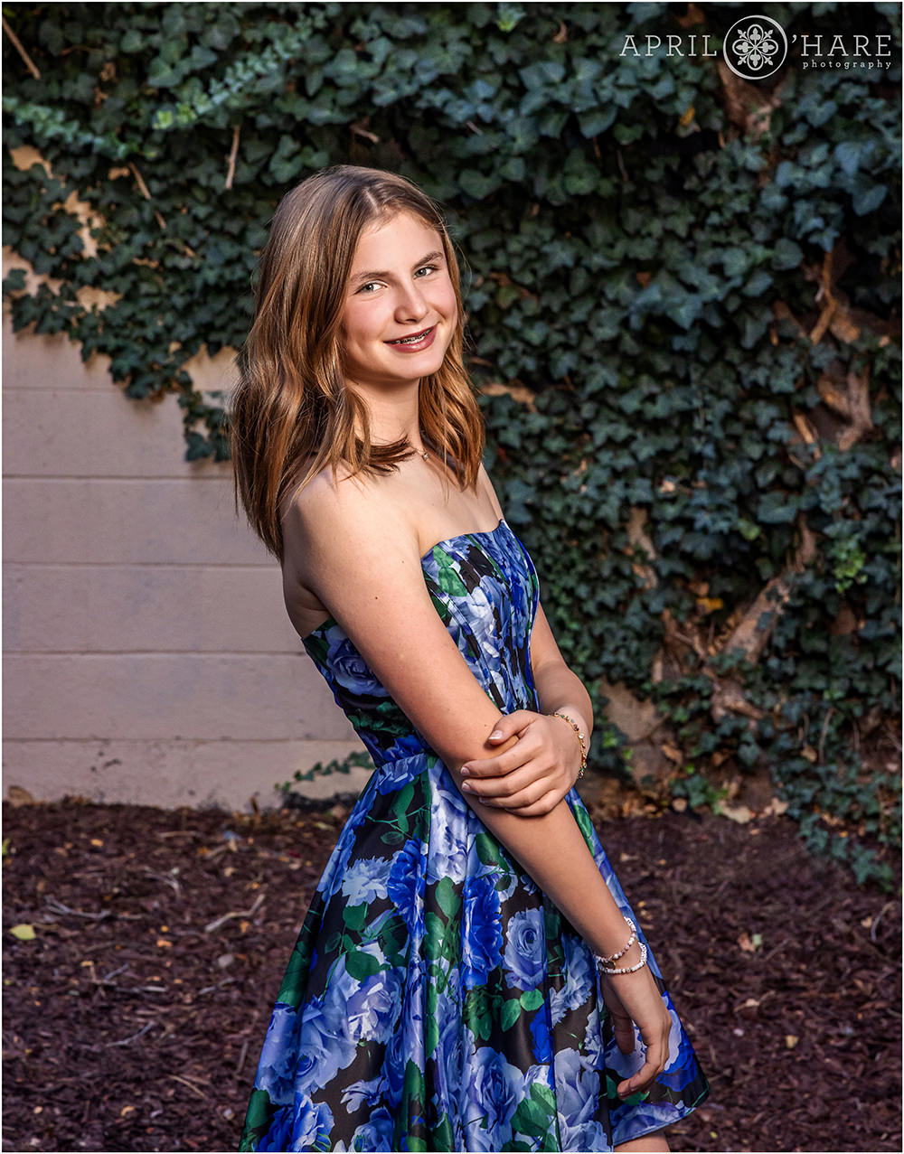 Bat Mitzvah Girl poses in front of an ivy wall in the alley at Rembrandt Yard in Boulder Colorado