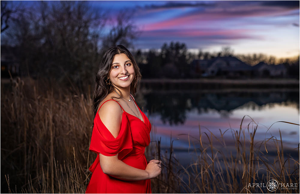 Beautiful pink and blue sunset sky senior portraits at home in Colorado