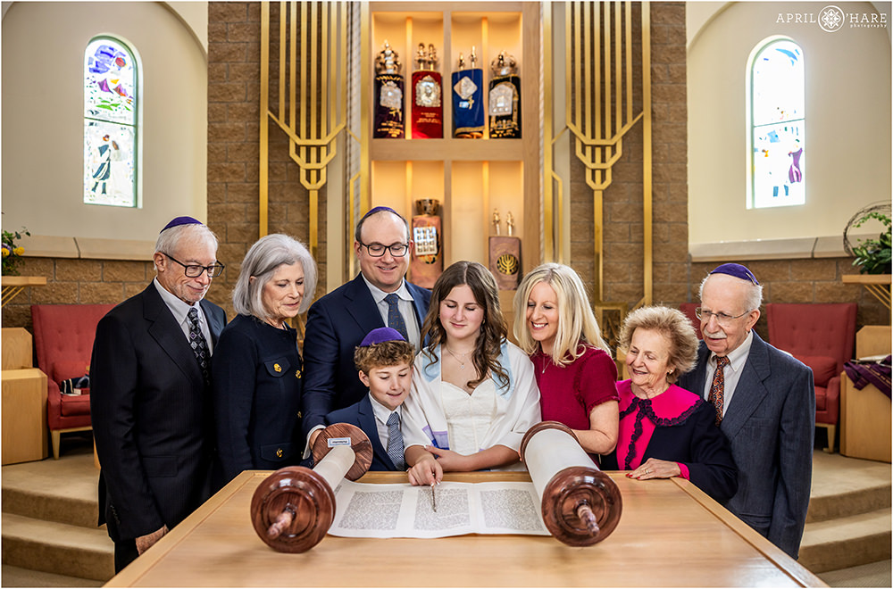 Grandparents and immediate family by her side and reading from the Torah for her bat mitzvah at Hebrew Educational Alliance