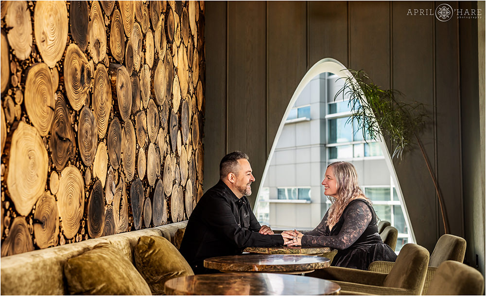 Couple sit at a table inside of Stellar Jay at the Populous Hotel before their birthday party brunch begins