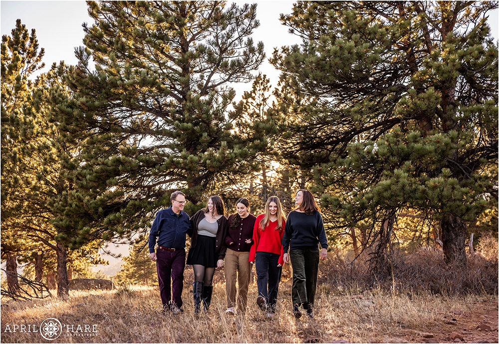 A family of five walk through the woods in Boulder Colorado