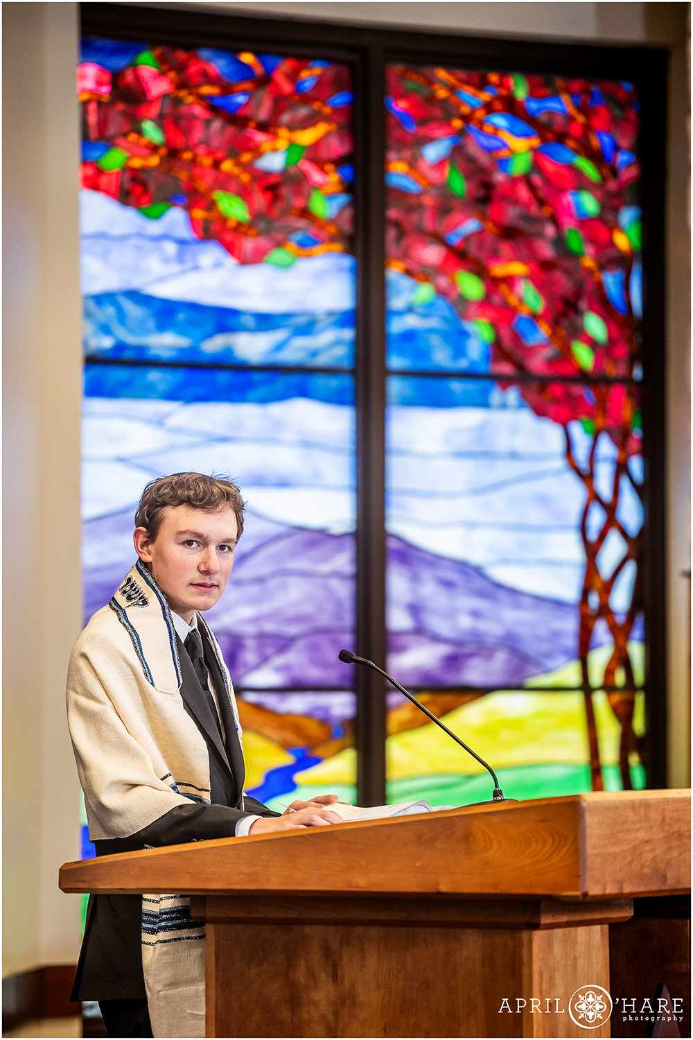 Bar mitzvah rehearsal photo in front of the pretty stained glass window at Temple Sinai in Denver CO