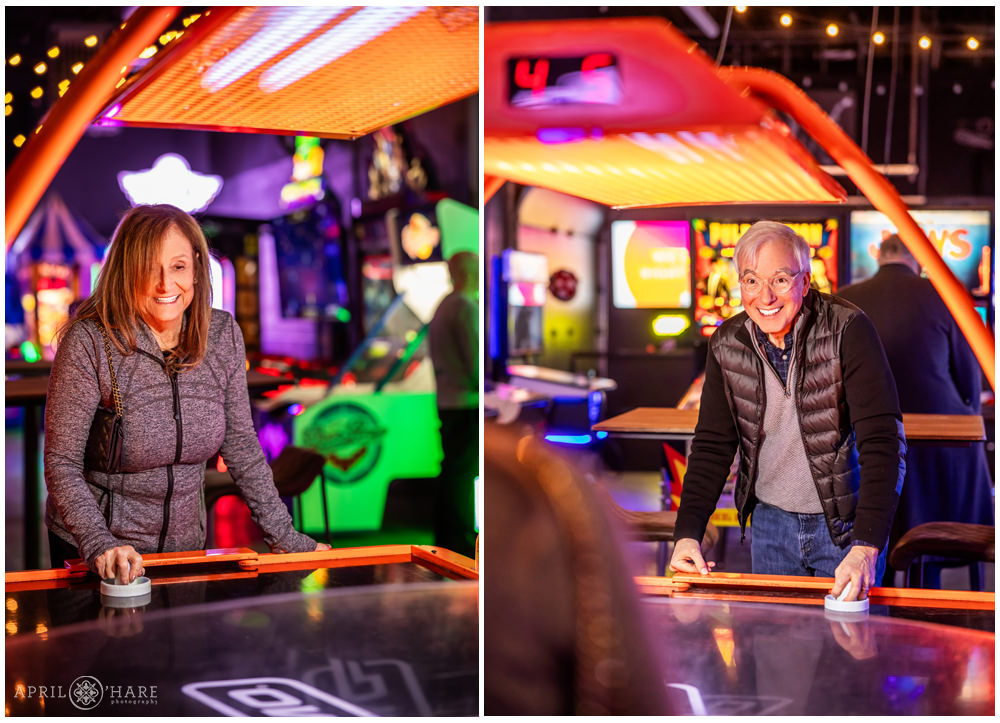 Grandparents play air hockey at their son's bar mitzvah party at Super Awesome Fun Factory in Denver CO