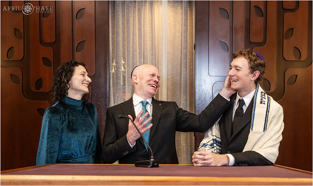Parent speeches as they laugh with their son on the day of his bar mitzvah rehearsal at Temple Sinai