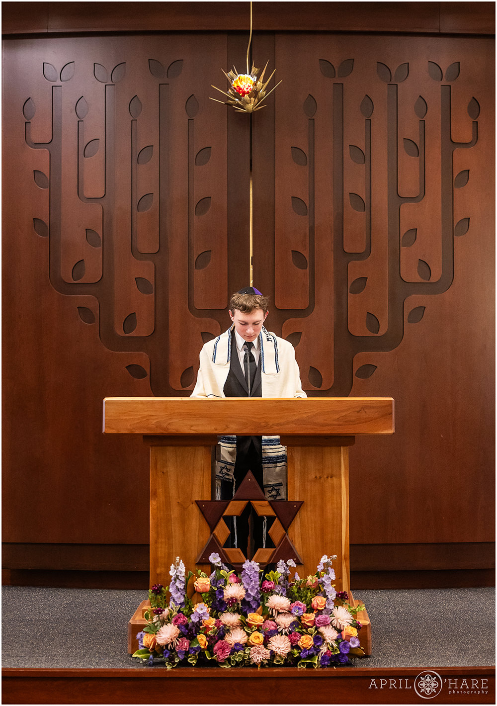 A young man at his bar mitzvah rehearsal at Temple Sinai in Denver, CO