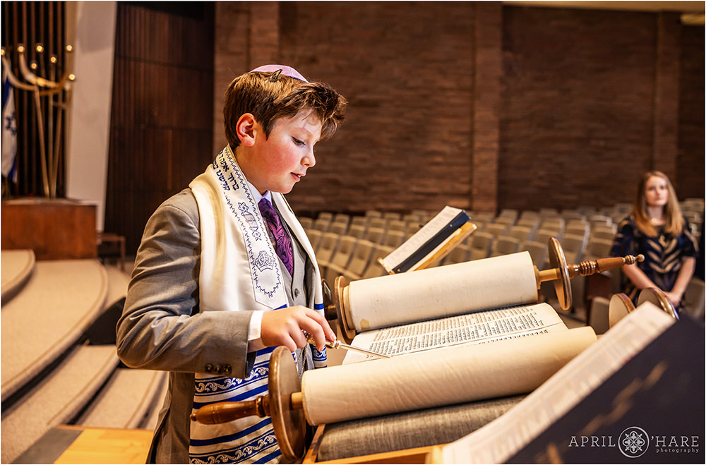 A young man reads from the torah at Temple Emanuel