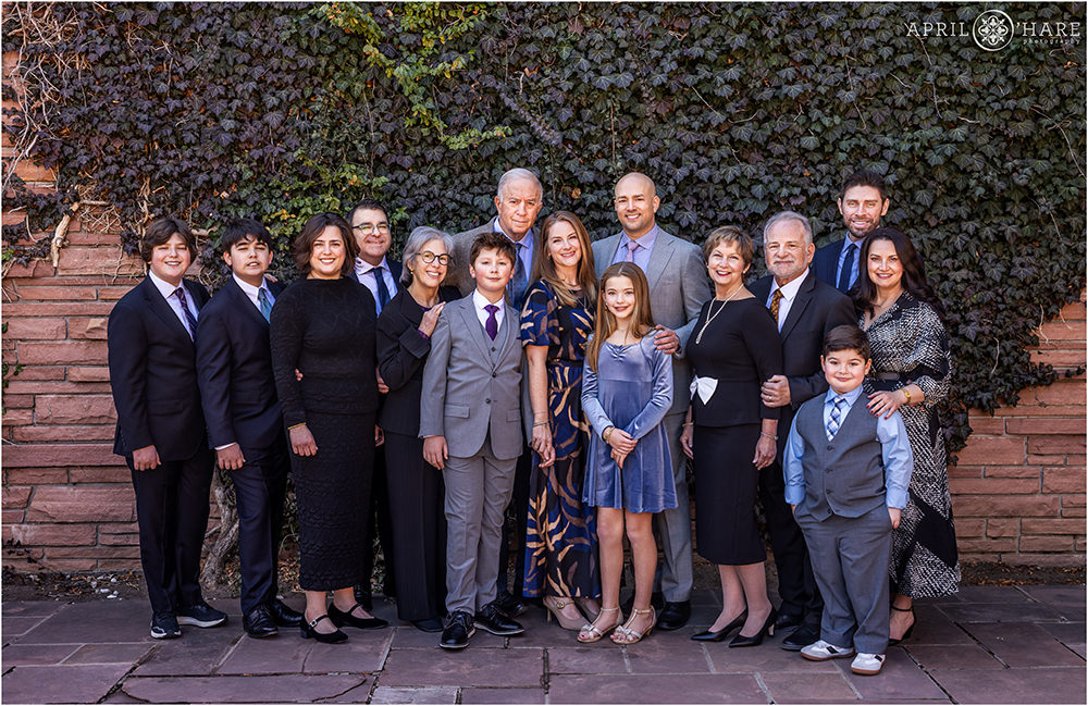 A beautiful large family photo with ivy wall backdrop at a bar mitzvah at Temple Emanuel in Denver, CO