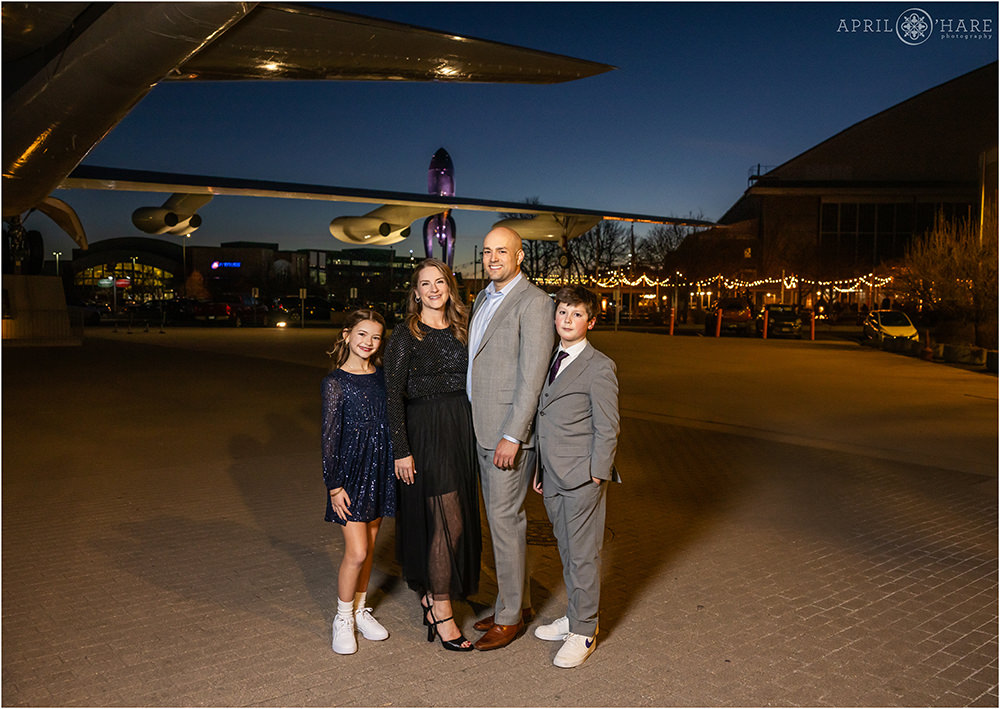 A family of four at dusk outside of Wings Over the Rockies at their son's bar mitzvah party