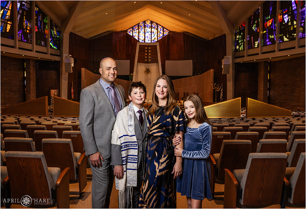 A jewish family of four pose for a photo together inside Temple Emanuel on the day of their son's bar mitzvah in Denver Colorado