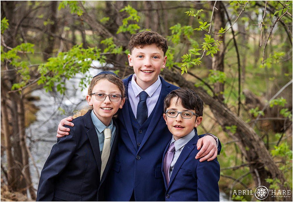A bar mitzvah boy with his brothers during spring on the day of his rehearsal at Congregation Bonai Shalom