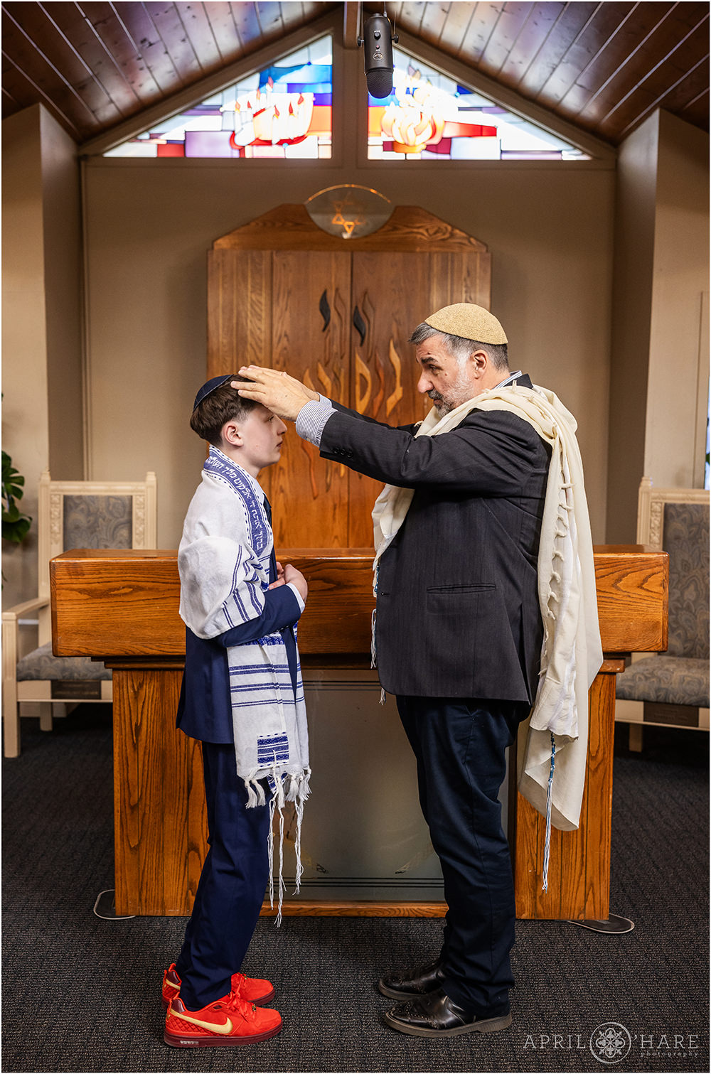 Rabbi gives bar mitzvah boy a blessing at Bar Mitzvah Rehearsal at Congregation Bonai Shalom