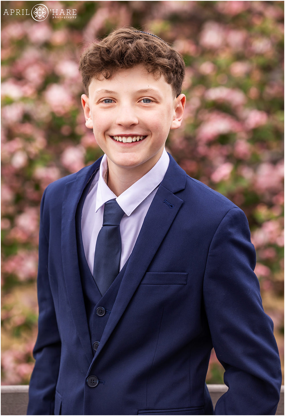 Spring time Bar Mitzvah Photo in front of a tree full of spring blossoms in Boulder Colorado