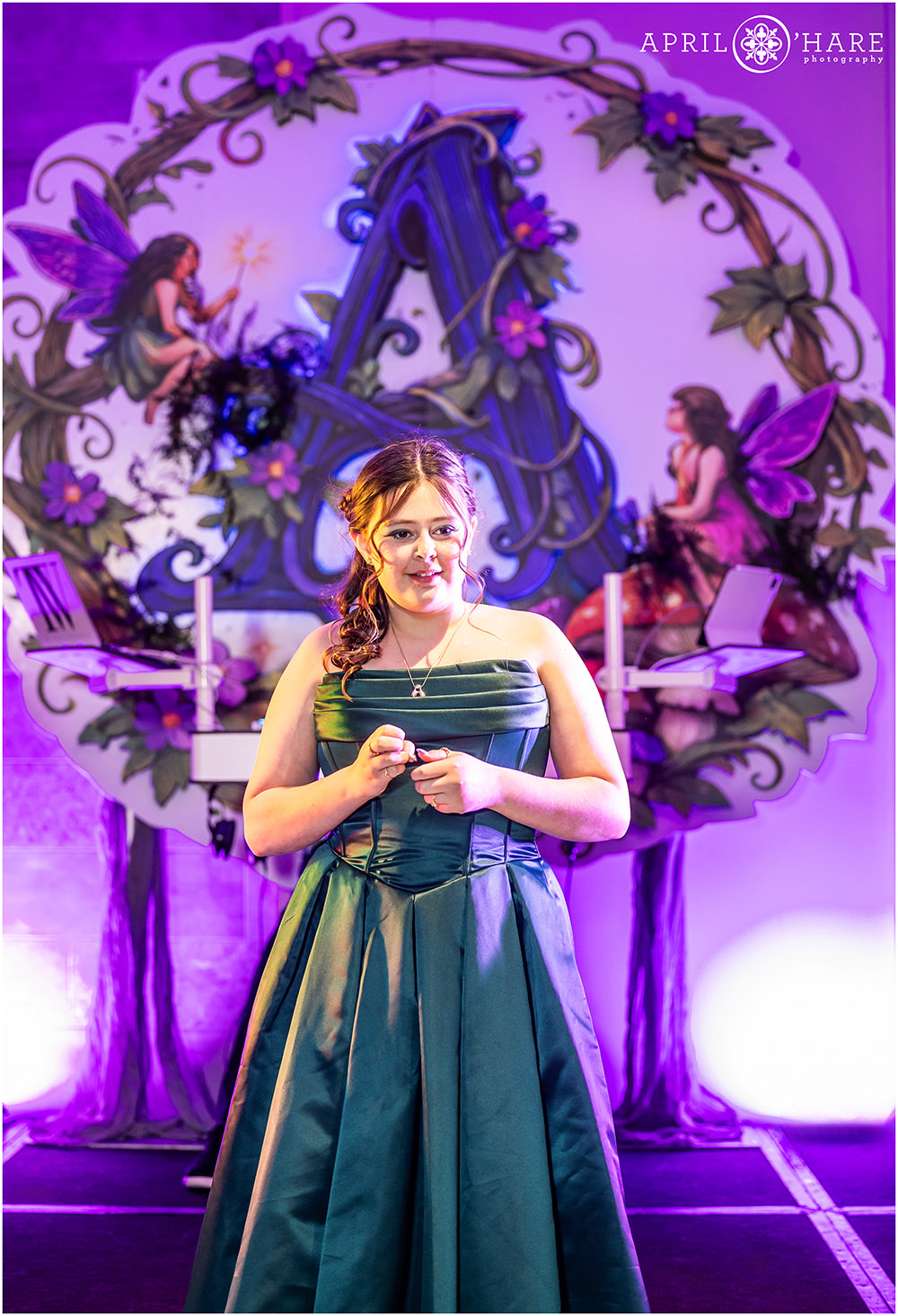 Bat Mitzvah girl with her custom DJ backdrop for her Midnight Magical Fairy Garden themed party in Denver