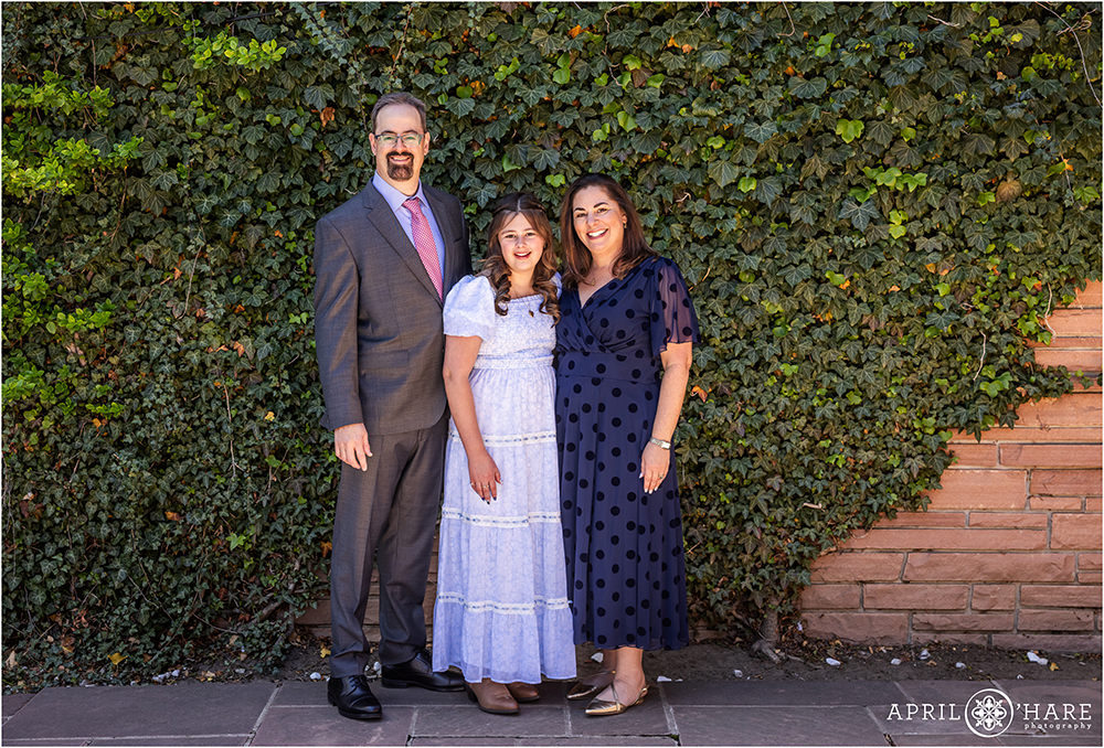 Classic family portrait in front of the Ivy Wall at Temple Emanuel on a bright sunny day in Denver
